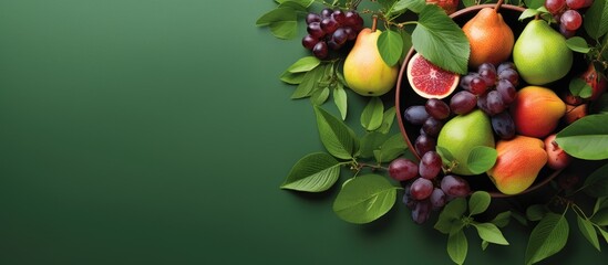 Copy space image of grape peach and pear fruits arranged on a green background with leaves viewed from above in a pot - Powered by Adobe