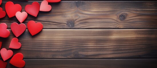 Valentine s Day themed copy space image with red paper hearts displayed on a wooden background