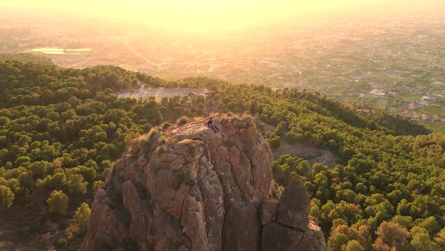 Sportsman rock climbing aerial view of sportsman rapelling mountain in La Panocha, el Valle Murcia, Spain woman rapel down a mountain climbing a big rock