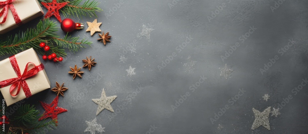 Poster Christmas presents with red ribbon on gray background in a frame made of fir branches with star Flat lay top view Christmas background. copy space available