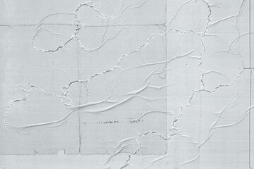 A close-up photo of wrinkled white copier paper texture on a poster, showing the creases and folds.