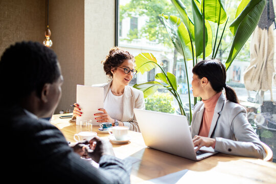 Business meeting in a cafe with diverse professionals