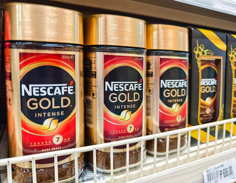 Closeup of Nescafe Gold Intense coffee jars on supermarket shelf.