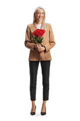 Full length portrait of a woman in formal clothes holding a bunch of red roses