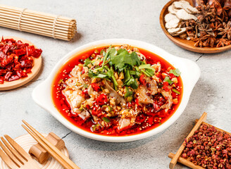 Spicy Saliva chicken with red chilli, chopsticks and fork served in pot isolated on background side view of taiwanese food