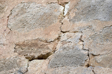 Big crack. Large winding deep crack in an old stone plastered wall. Close-up. Selective focus. Copy...
