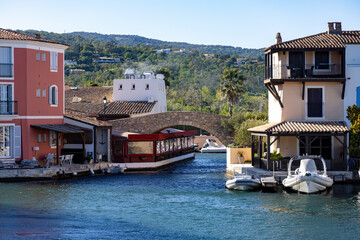 Downtown of Port Grimaud in France with cafes, restaurants, yachts and sailboats in spring