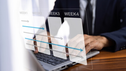 Businessman using computer for working plan by weekly for business and work.