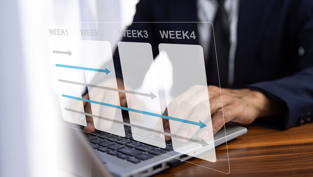 Businessman using computer for working plan by weekly for business and work.