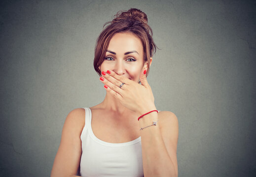 young shy woman smiling and playfully looking at camera