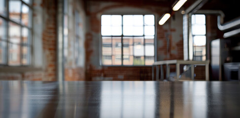 Empty table in industrial loft office space. Sleek empty table with blurred industrial style office space in the background, perfect for product placement or design mockup.