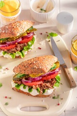 Homemade sandwich with pulled beef, tomato and lettuce.