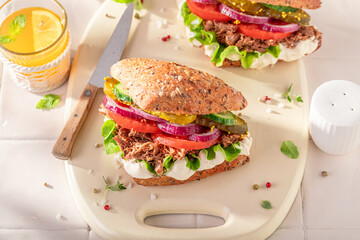 Homemade sandwich with pulled beef, gherkins and tomato.