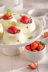 Homemade cheesecake monoportion with strawberries and vanilla glazed.
