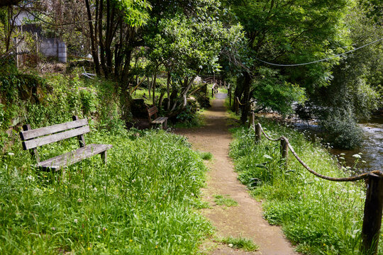Boiro (Spain), May 23, 2024. Wooden walkway on a path that reaches the Goi&aacute;ns mills, old water mills that have been rehabilitated