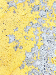Faded, damaged yellow, gray cracked cement surface background texture