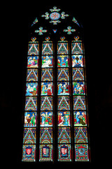 Colorful stained glass window in a gothic style shape inside the Matthias Church at the Holy...