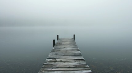 Naklejka premium Extending jetty onto the foggy lake