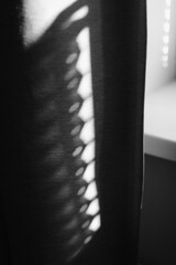  shadow of the rays falling on the wall through curtains. Abstract shadow and striped diagonal light background from window, backdrop and mockup design. black and white