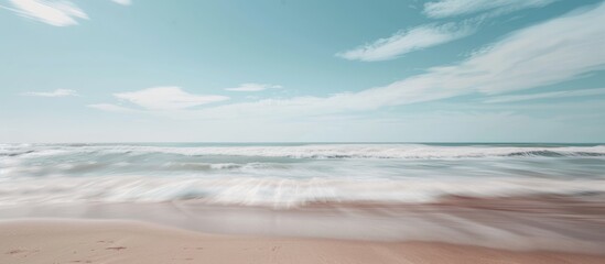 Blurred ocean serving as a backdrop for a sandy beach in summer
