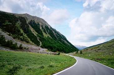 Asphalt road in Alps mountains. Road trip concept. Beautiful landscape.