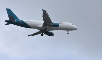 a plane landing with gray sky