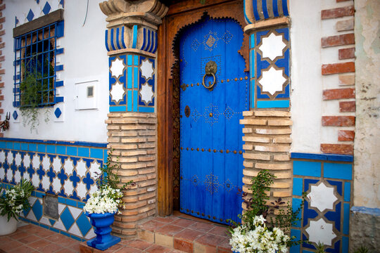 Beautiful ornate deep blue door in an eclectic style in the historic center of Hell&iacute;n, Albacete, Castilla la Mancha, Spain