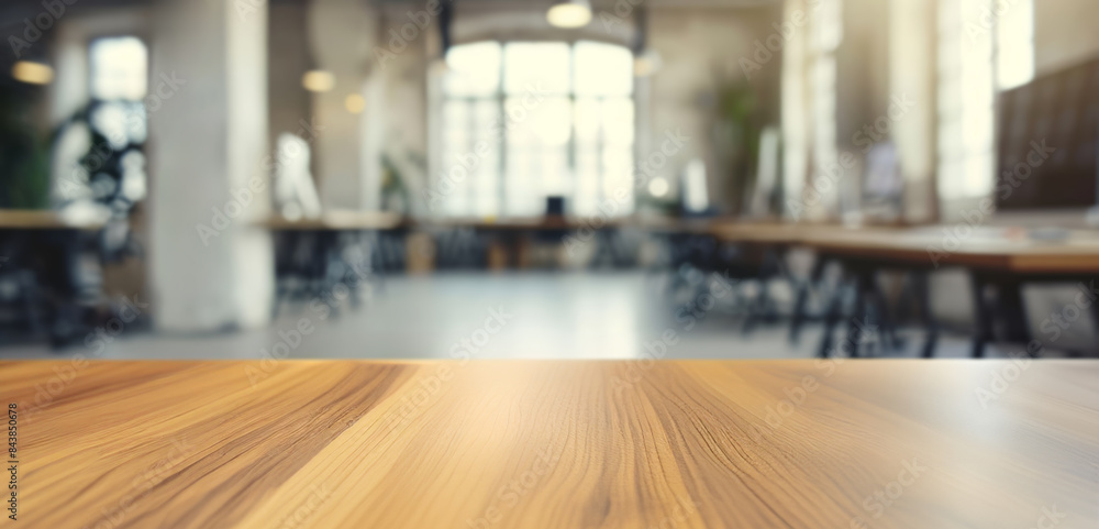 Poster empty wooden table in modern office interior. blurred background of modern open space office with em