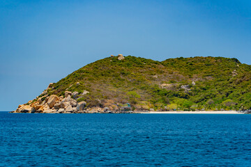 A steep bank.
The rocky shore of the island in the sea. 