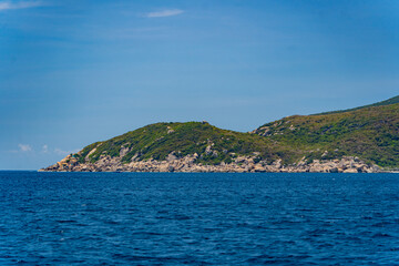 A steep bank.
The rocky shore of the island in the sea. 