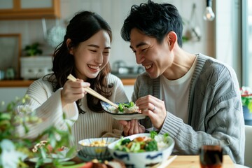 A japanese couple happily enjoying a meal together at home, white clean modern living room