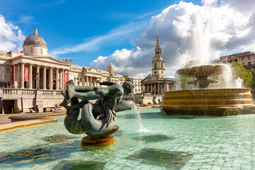 Fountain on Trafalgar square with National Gallery at background, London, UK
