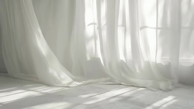 White curtain is hanging in front of window, letting in sunlight