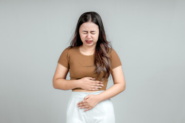 Portrait of a young girl with an expression of pain in her stomach. Stomach ache