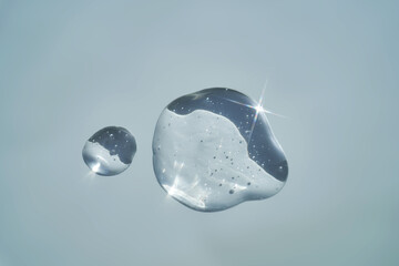 Drop of serum shimmering in the sun on a blue background.