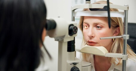 Woman, optometry and slit lamp with machine, vision or care in wellness assessment for eyesight at...