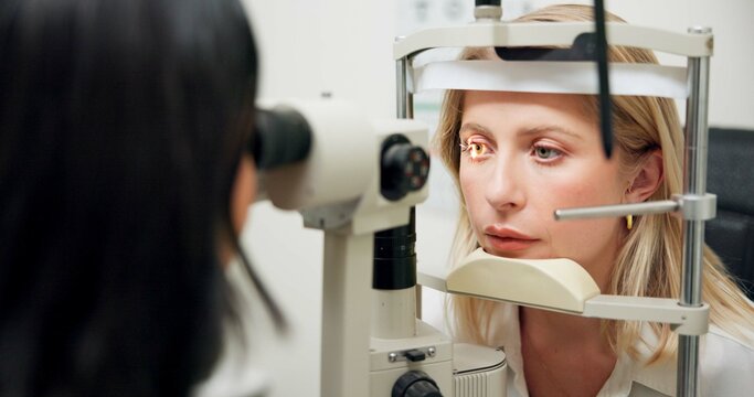 Woman, optometry and slit lamp with machine, vision or care in wellness assessment for eyesight at clinic. Person, check and patient for health, light and laser for retina scan with lens for eye exam