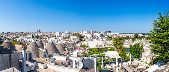 View of Alberobello and famous historic dry stone trulli houses with conical roofs. Italy.