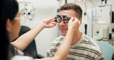 Optometrist, patient and assessment in clinic for eye exam, optometry and vision with phoropter. Specialist, man and testing machine in hospital for healthcare, wellness or ophthalmology for glaucoma