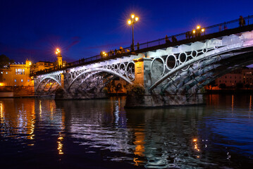 Triana Bridge Over The Guadalquivir River At Nightfall, Seville