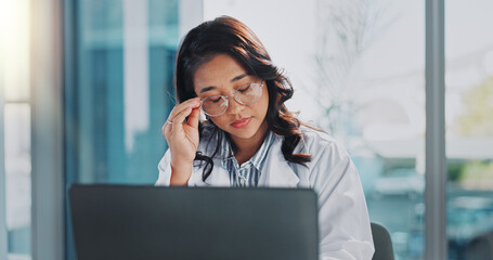 Stress, doctor and Asian woman on laptop in hospital for medical service, telehealth and research. Healthcare, clinic and person on computer with headache, frustrated and burnout for mistake or fail