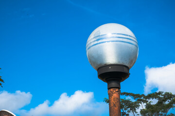 Street white round lighting lantern against the sky. Close-up.