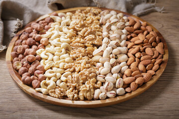plate of mixed nuts on wooden table