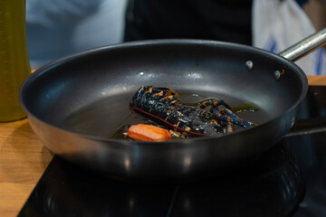 lobster grilling in a frying pan. homarus gammarus