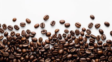 Roasted Coffee Beans Scattered On A White Surface