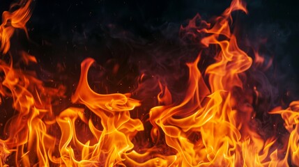 Fototapeta premium Texture of fire flames on black background. Burning red hot sparks