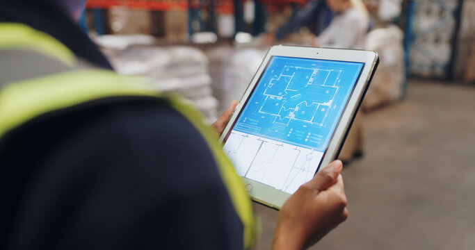 Hands, architect and tablet with app for blueprint in warehouse for building, design and ideas for inspection. Contractor, touchscreen and person for floor plan, review and factory for supply chain
