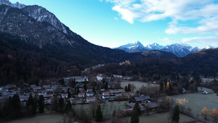 The fairytale-like Neuschwanstein Castle in Schwangau, Bavaria, Germany, with Mount Sauling in the background. The Bavarian King Ludwig II commenced the Castle in 1869.