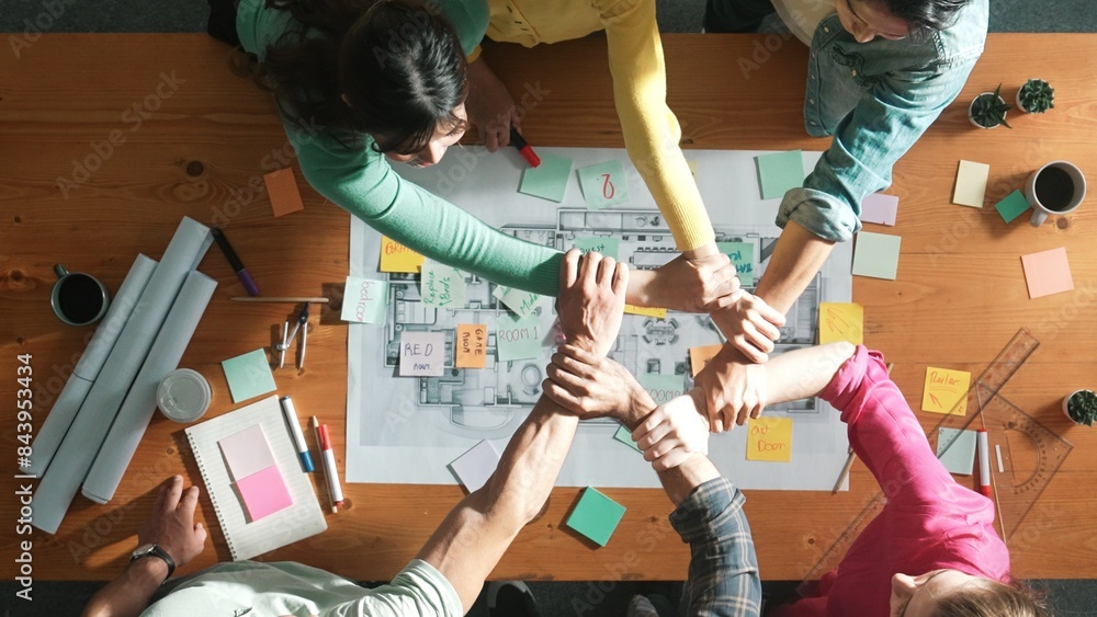 Poster top down view of business people working together and holding wrist. aerial view of architect engine