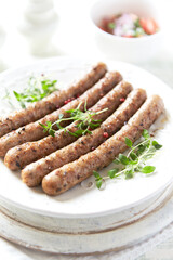 Roasted white sausages on bright wooden background. Copy spaces.	